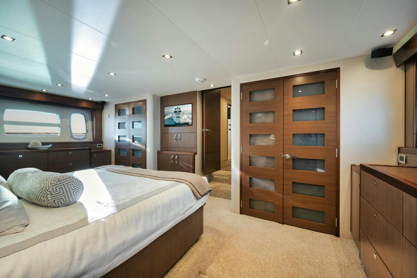 a bedroom with a bed and a cabinet aboard EMMY Yacht for Sale