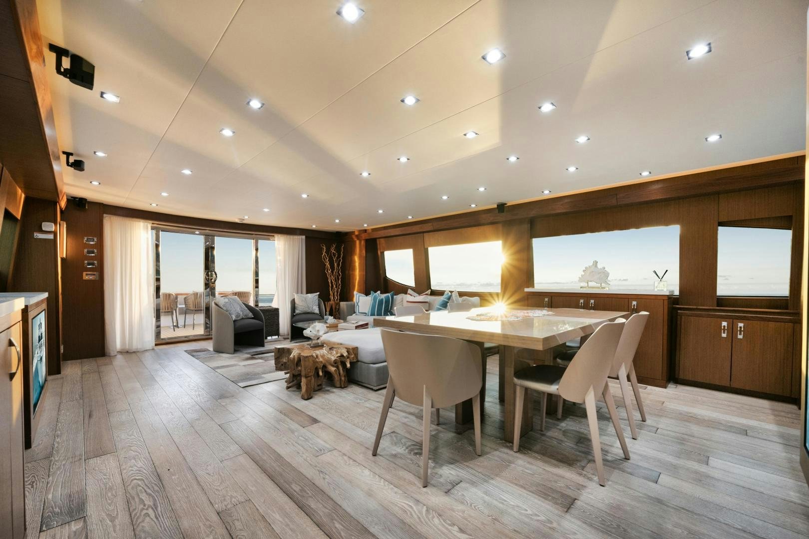 a large room with a table and chairs aboard EMMY Yacht for Sale