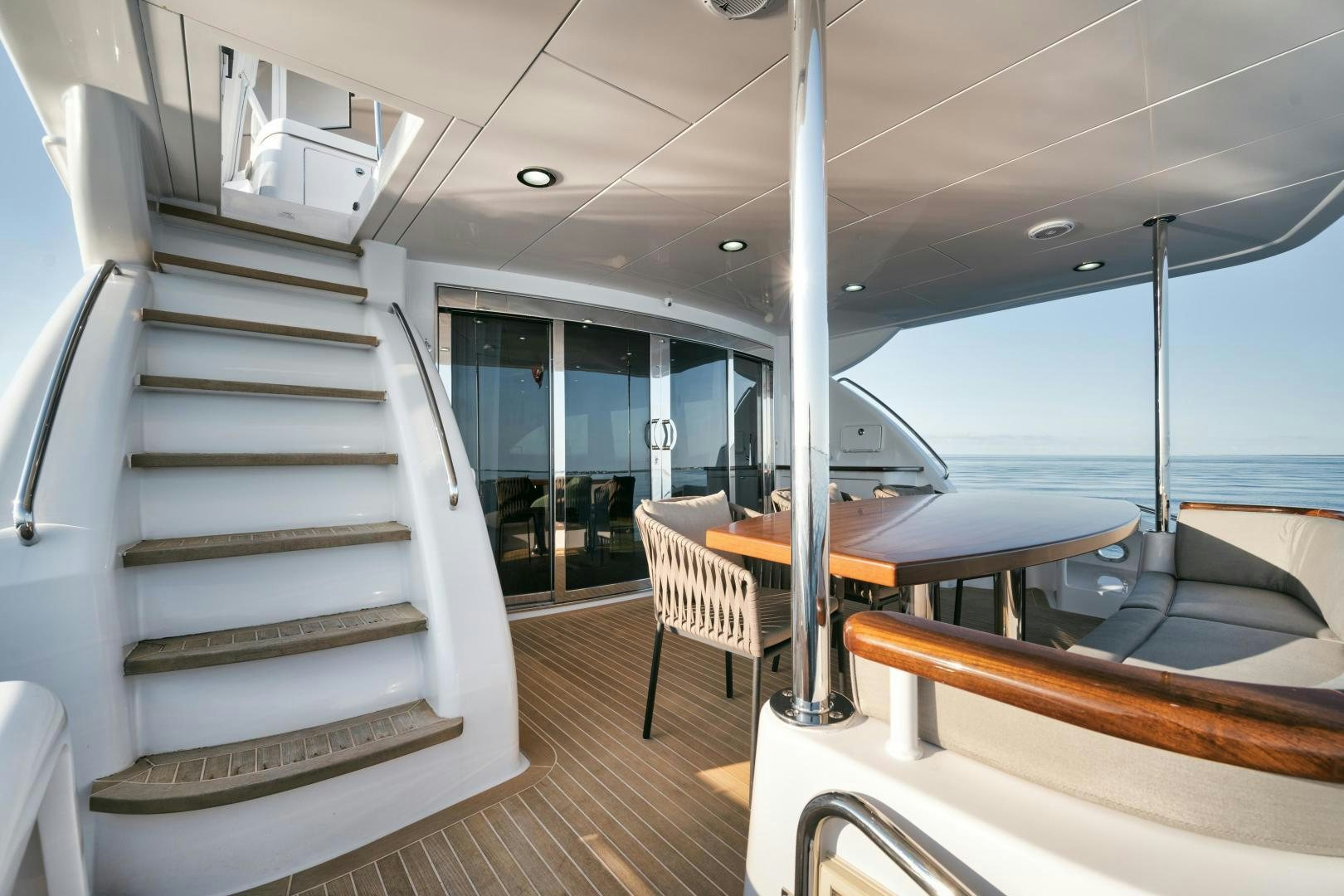 a boat with a staircase and a table and chairs aboard EMMY Yacht for Sale