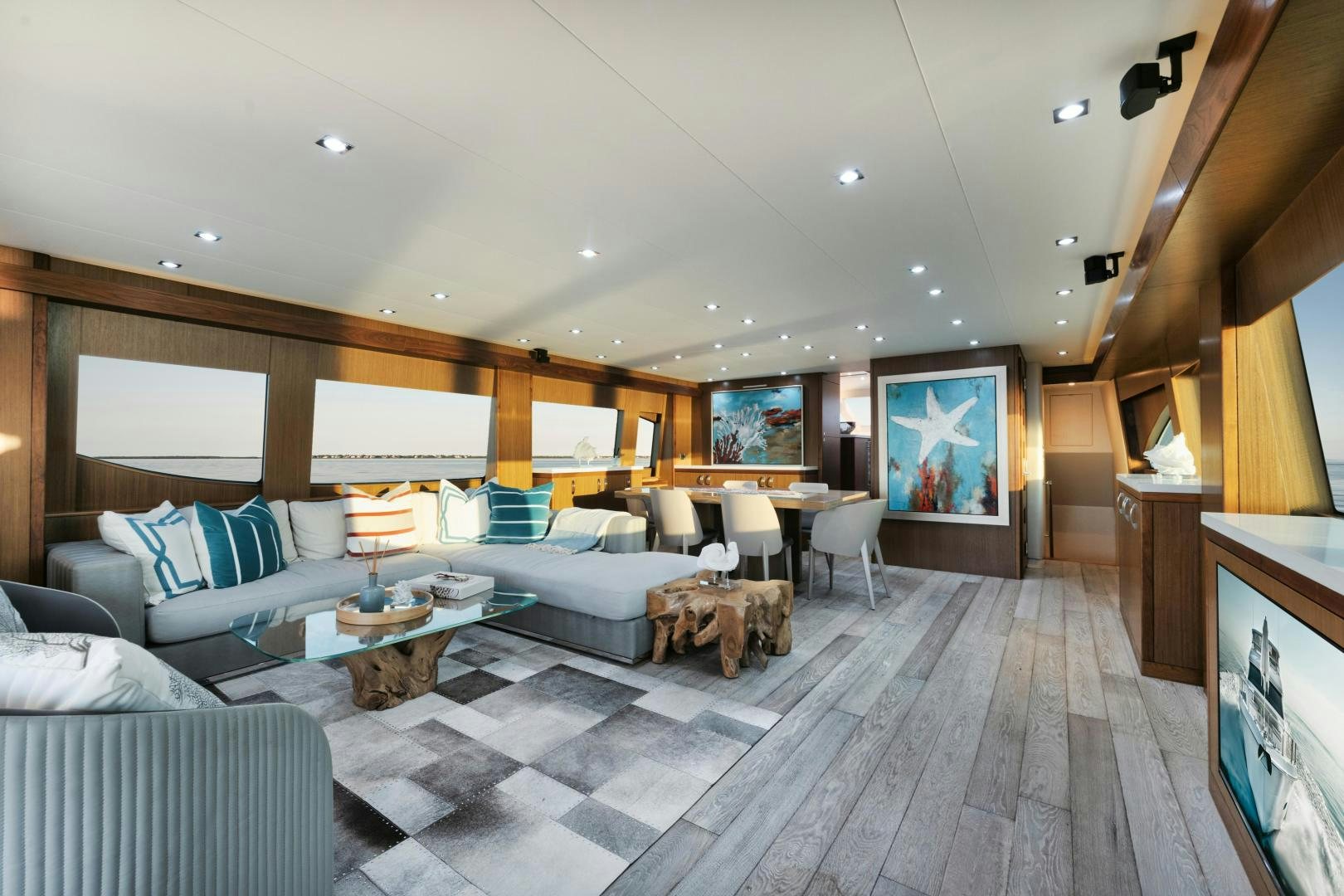 a large living room with a large screen aboard EMMY Yacht for Sale