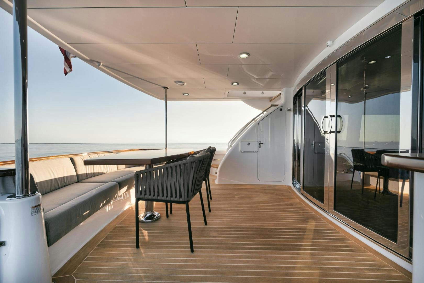 a room with a wood floor and a bench and a large window aboard EMMY Yacht for Sale