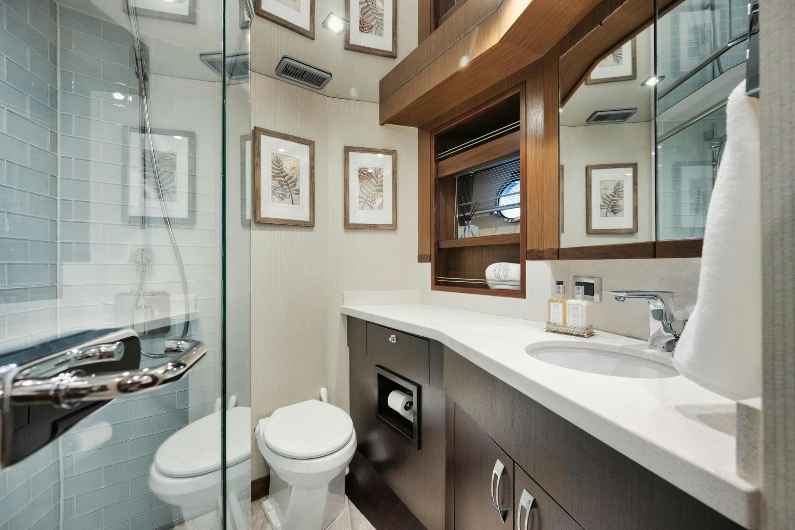 a bathroom with a sink toilet and a mirror aboard EMMY Yacht for Sale