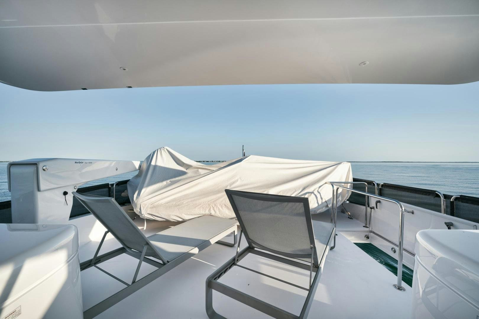 a deck with chairs and a table on it aboard EMMY Yacht for Sale