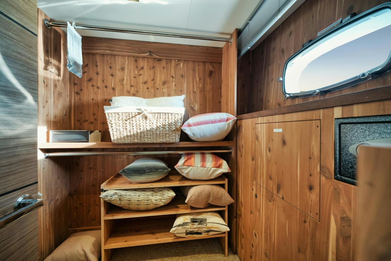 a wooden hutch with bowls and plates on it aboard EMMY Yacht for Sale