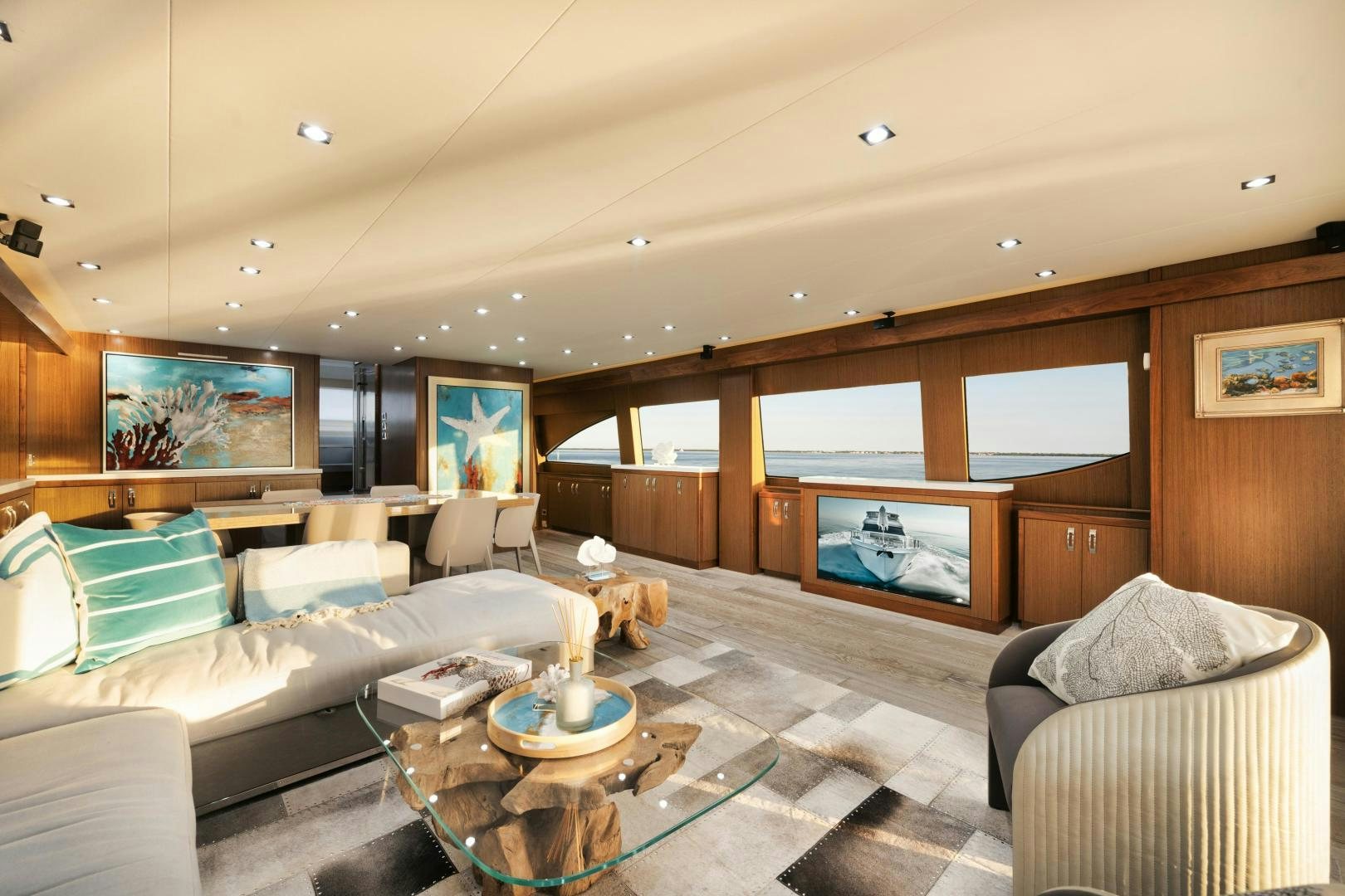 a living room with a large sofa and a fireplace aboard EMMY Yacht for Sale