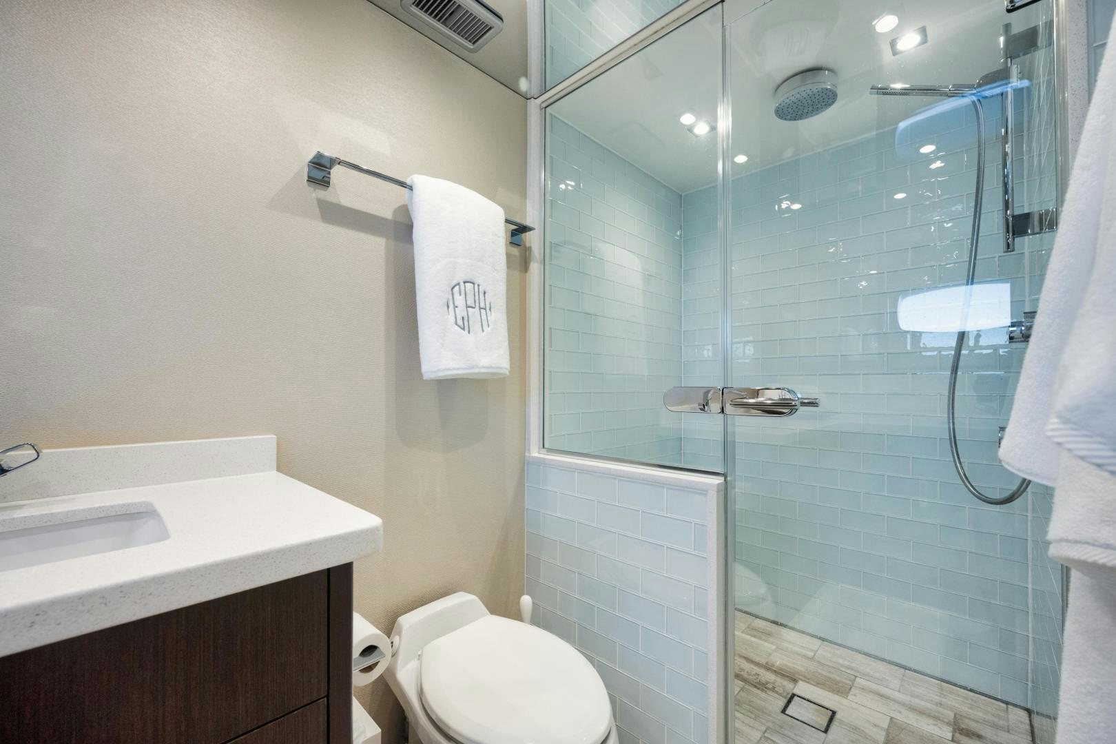 a bathroom with a glass shower door aboard EMMY Yacht for Sale
