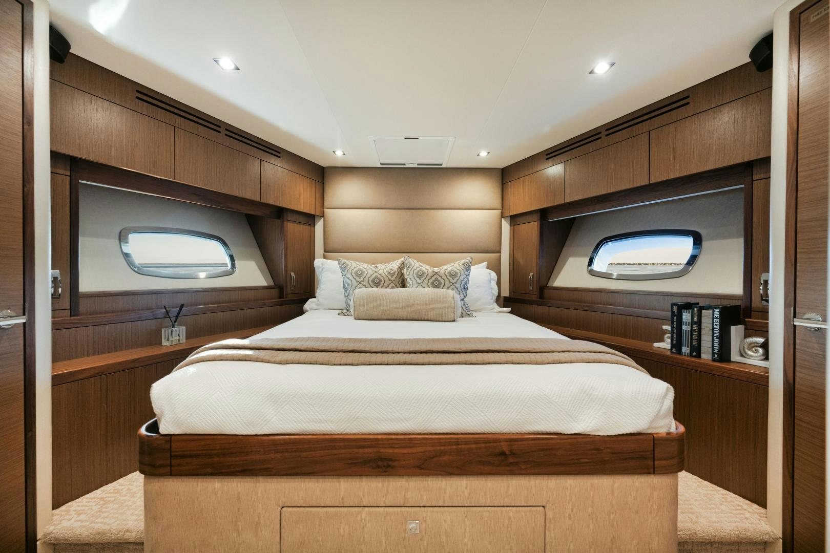 a bed with a wooden headboard aboard EMMY Yacht for Sale