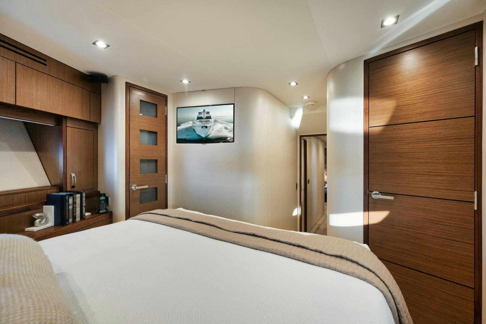 a bedroom with a bed and a closet aboard EMMY Yacht for Sale
