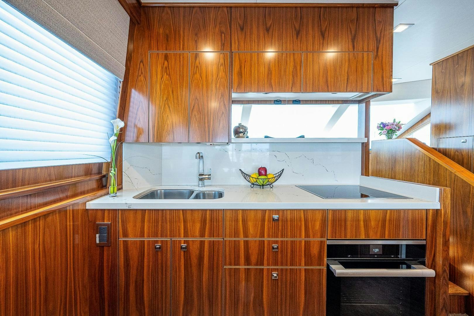 a kitchen with wooden cabinets aboard KALEEN Yacht for Sale