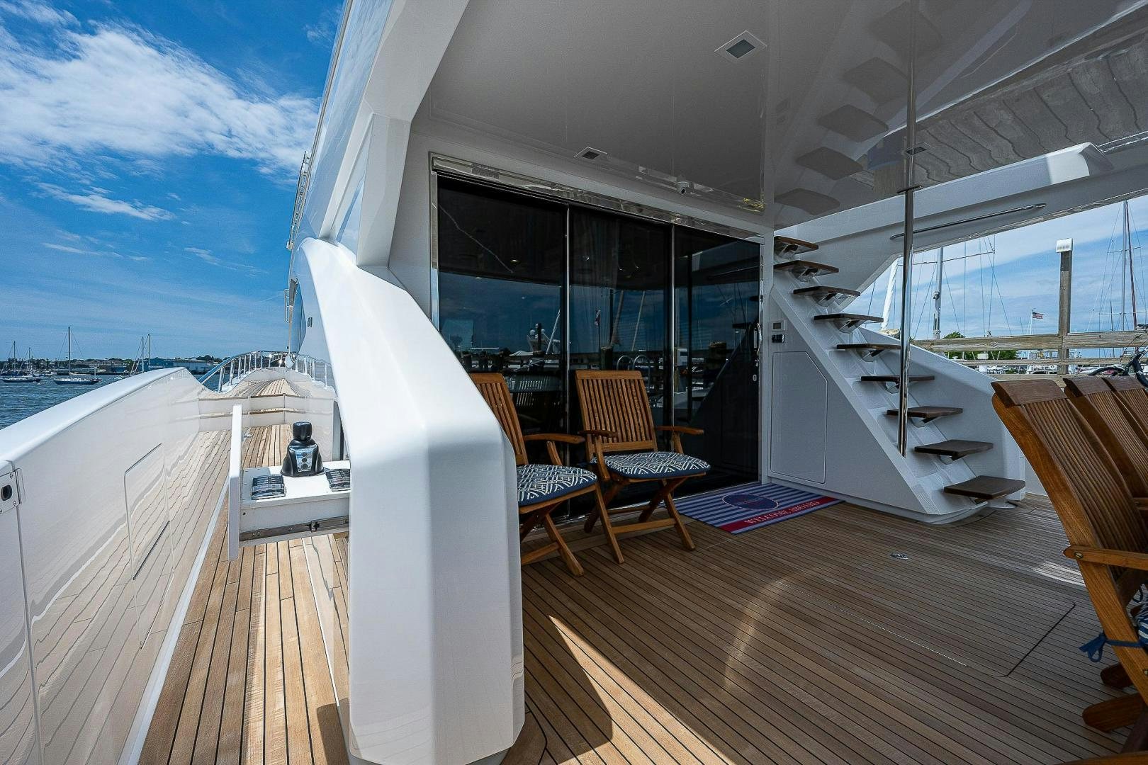 a large white surfboard on a deck aboard KALEEN Yacht for Sale