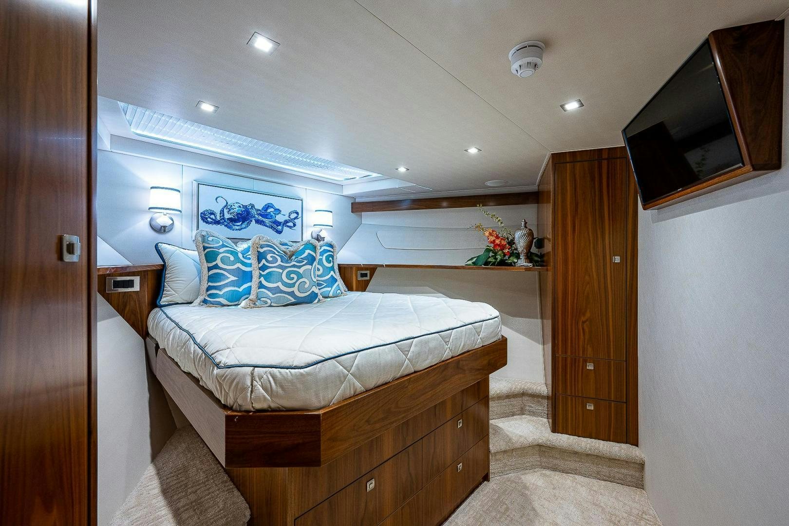 a bedroom with a bed and a wood door aboard KALEEN Yacht for Sale