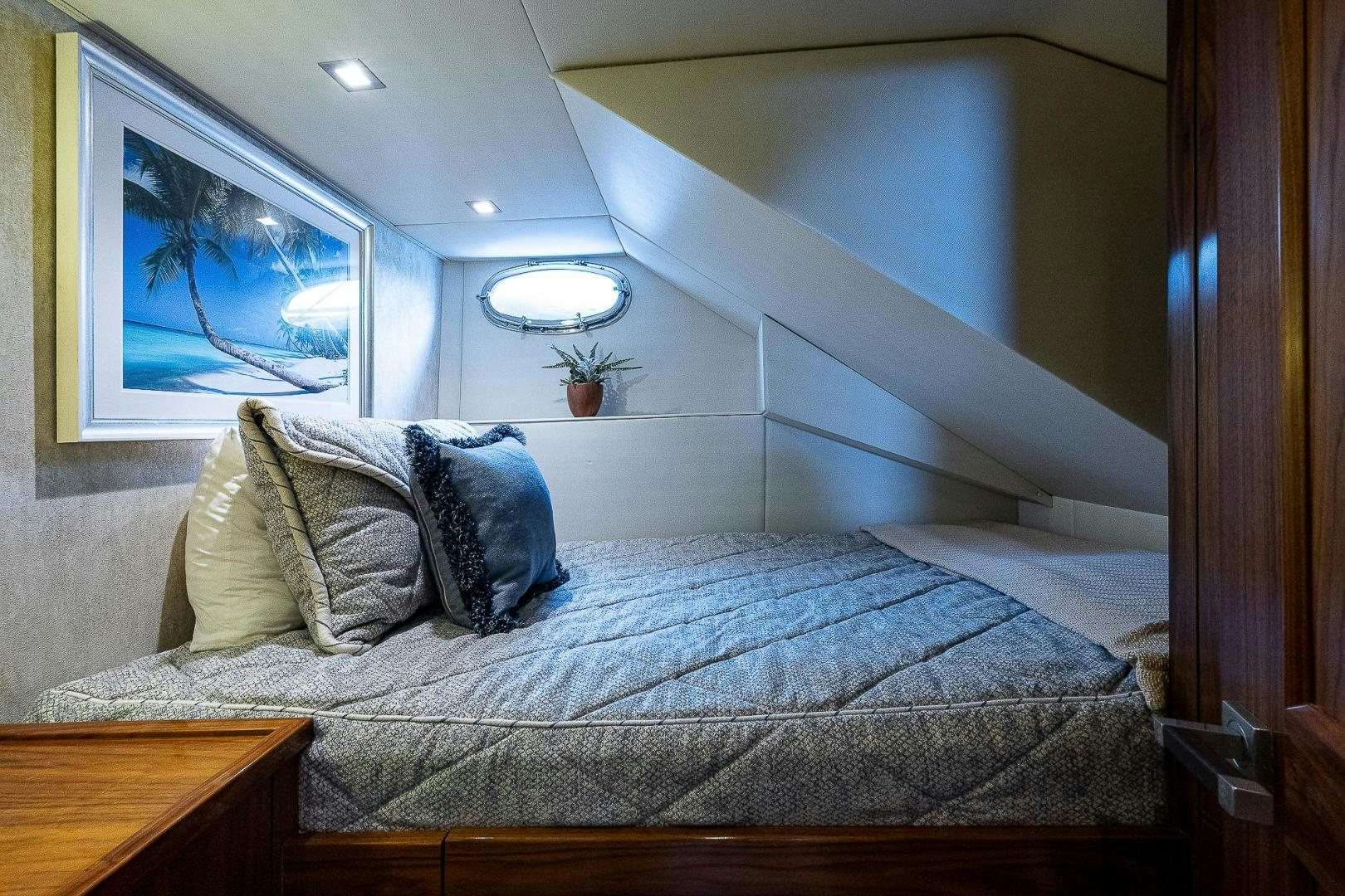 a bed with a blue comforter aboard KALEEN Yacht for Sale