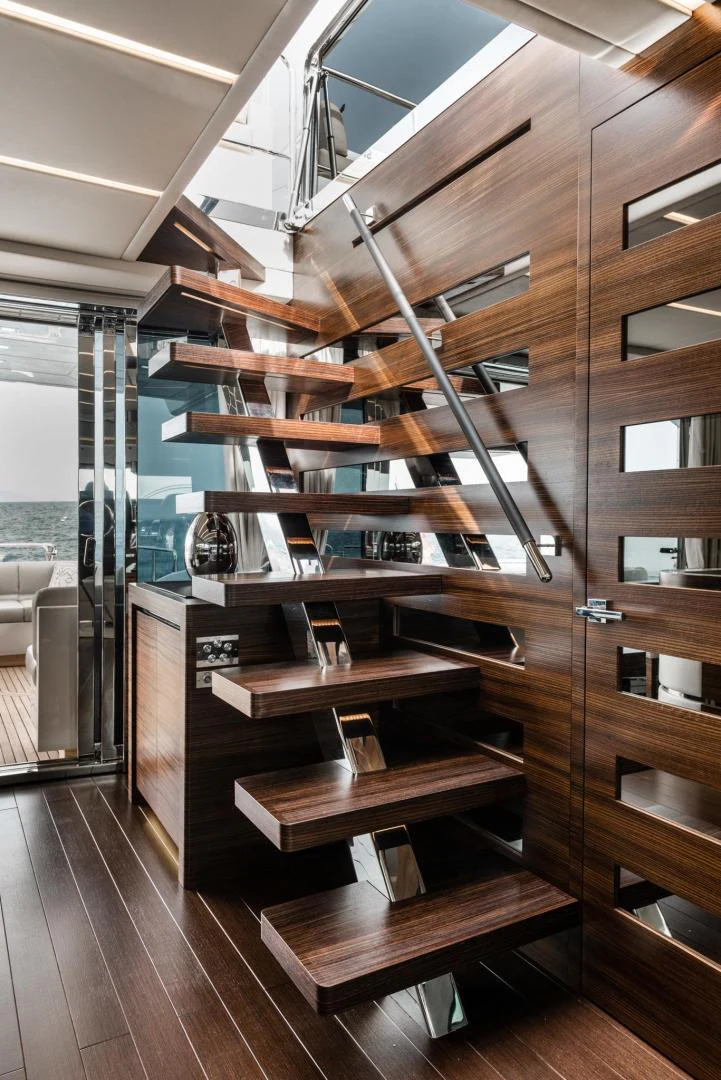 a wooden staircase with glass doors aboard WINGS SPREAD Yacht for Sale