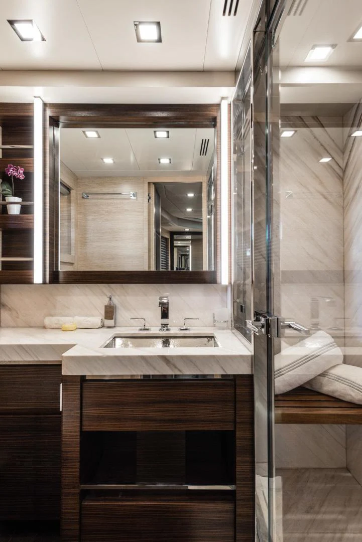 a bathroom with a large mirror aboard WINGS SPREAD Yacht for Sale