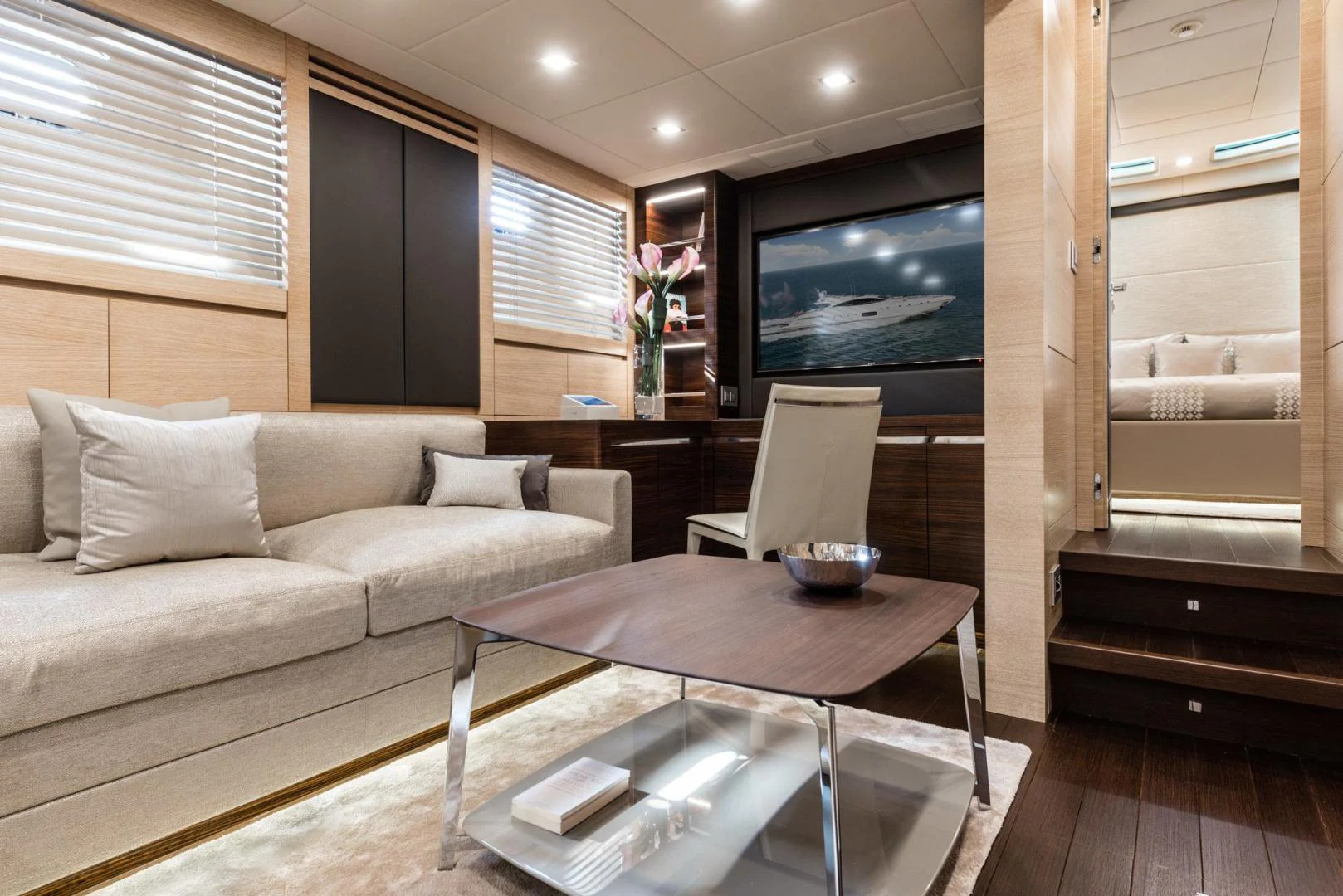 a living room with a couch and a coffee table aboard WINGS SPREAD Yacht for Sale