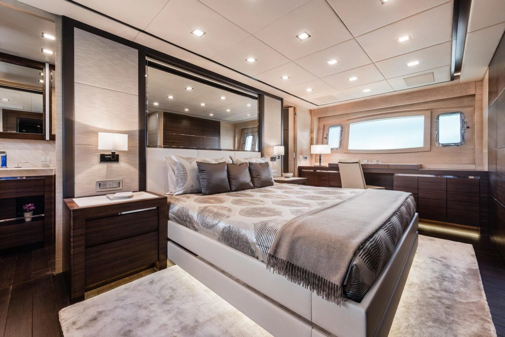 a bedroom with a bed and a desk aboard WINGS SPREAD Yacht for Sale