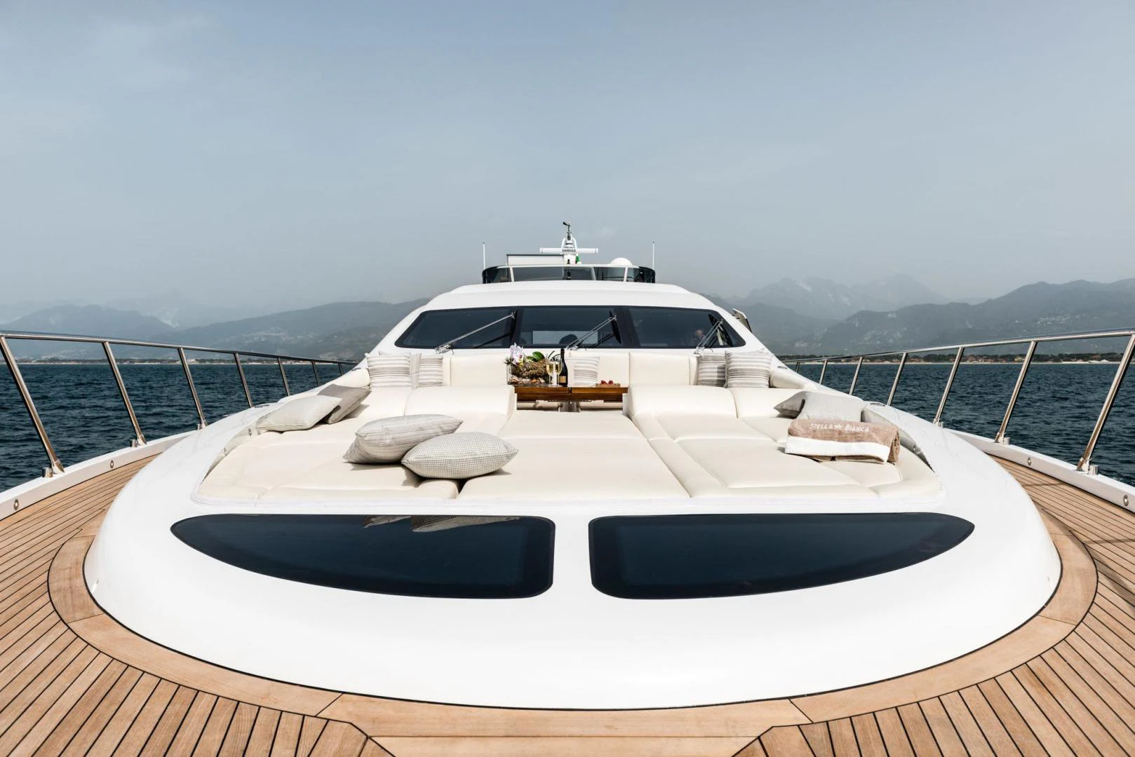 a white yacht on a deck aboard WINGS SPREAD Yacht for Sale