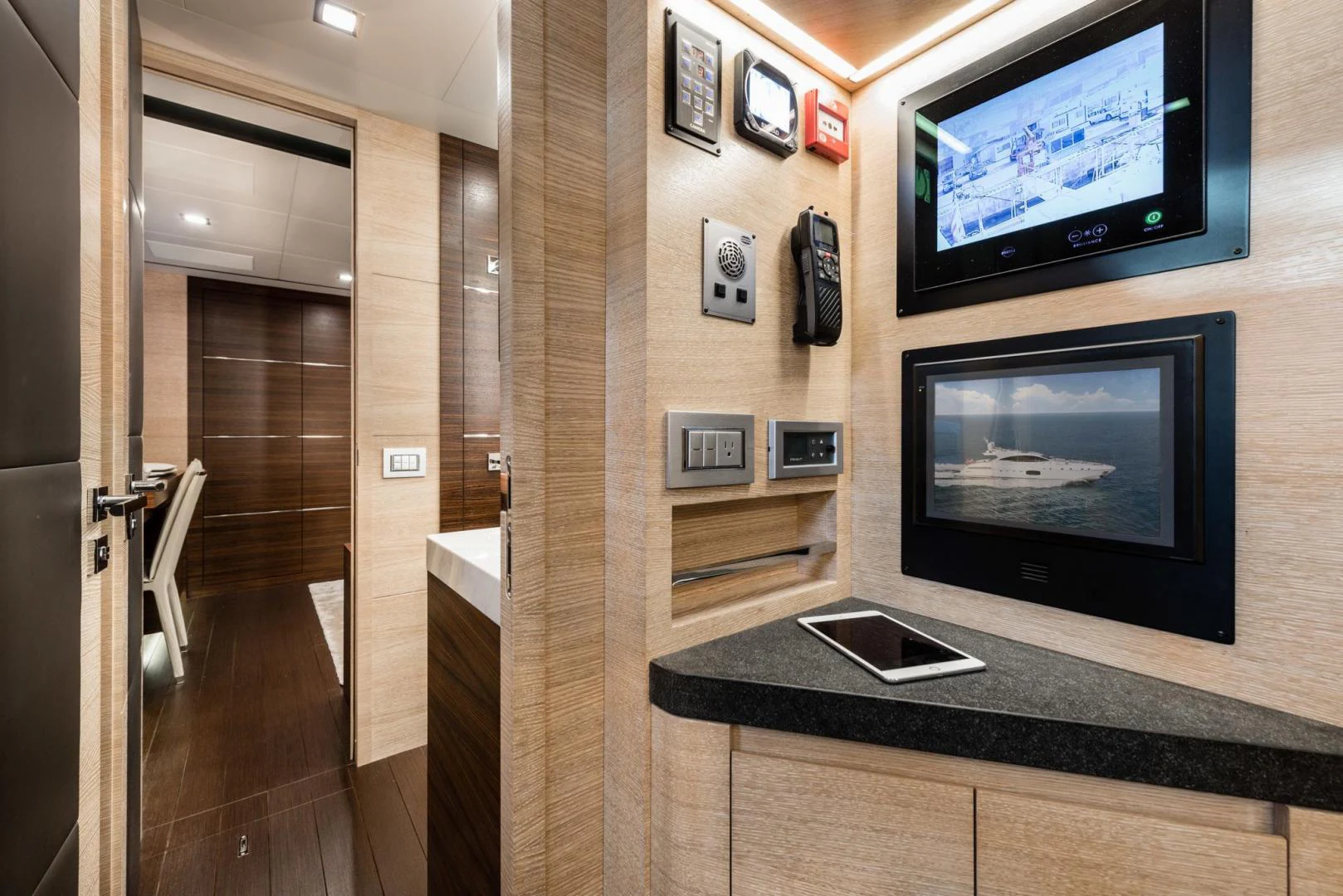 a room with a laptop and a tv on the wall aboard WINGS SPREAD Yacht for Sale