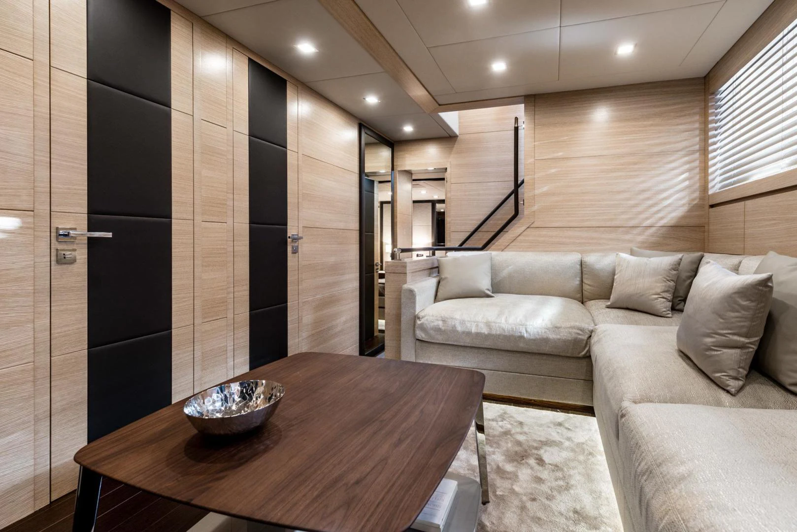 a living room with a couch and a table aboard WINGS SPREAD Yacht for Sale