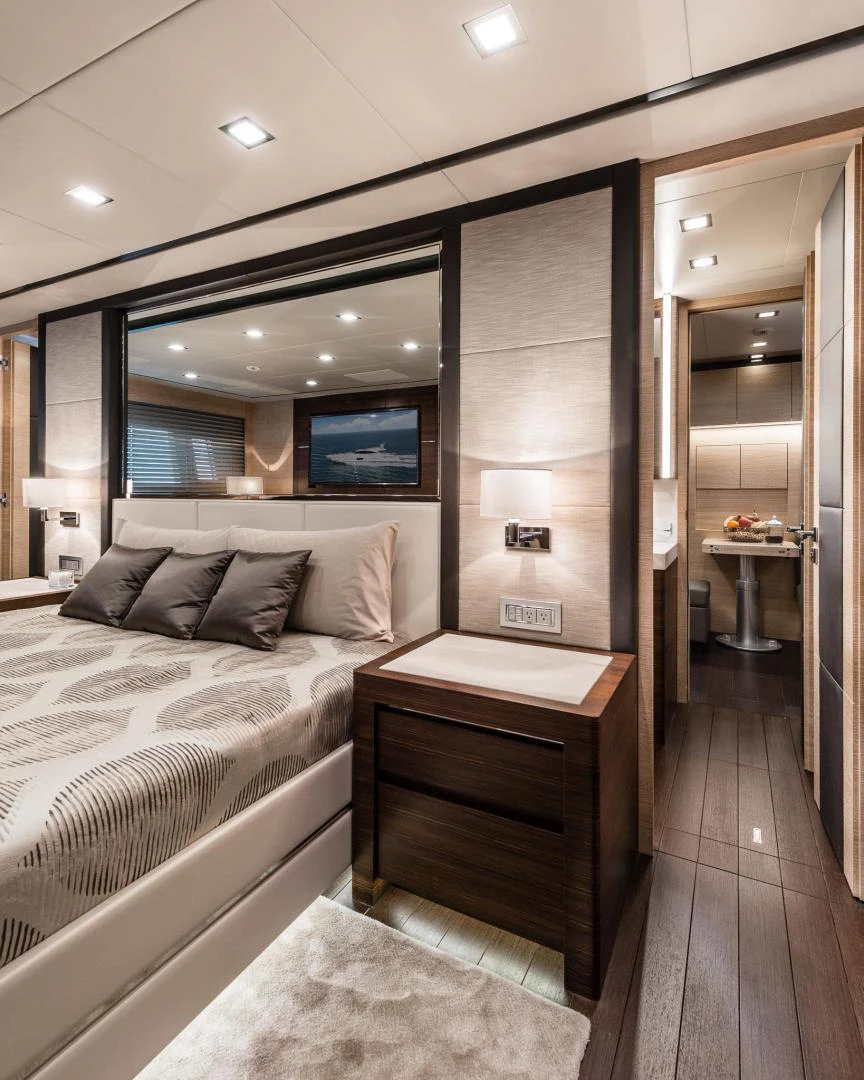 a bedroom with a bed and a mirror aboard WINGS SPREAD Yacht for Sale