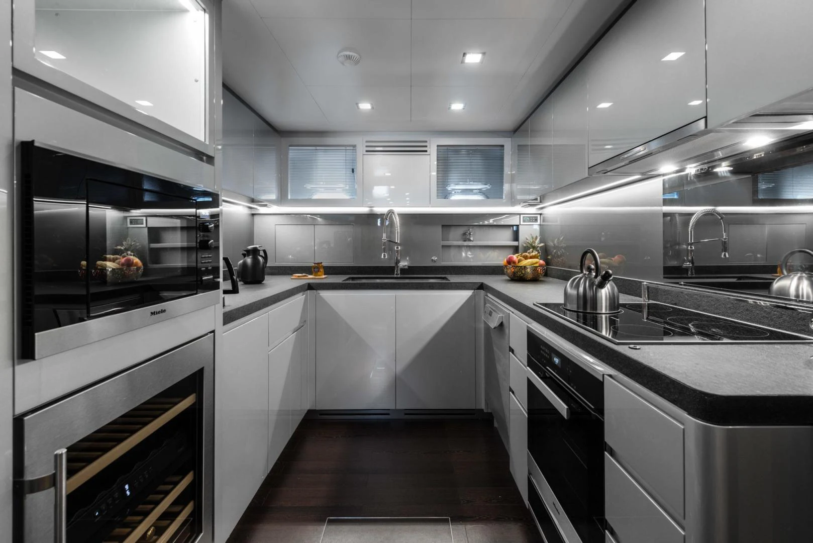 a kitchen with white cabinets aboard WINGS SPREAD Yacht for Sale