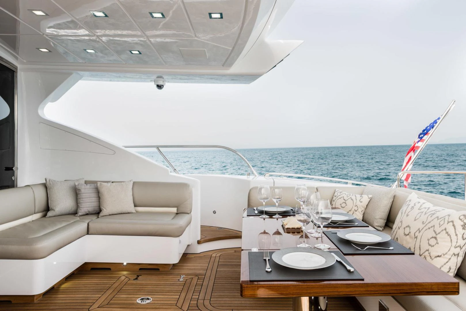a room with a couch and a table and a large pool aboard WINGS SPREAD Yacht for Sale