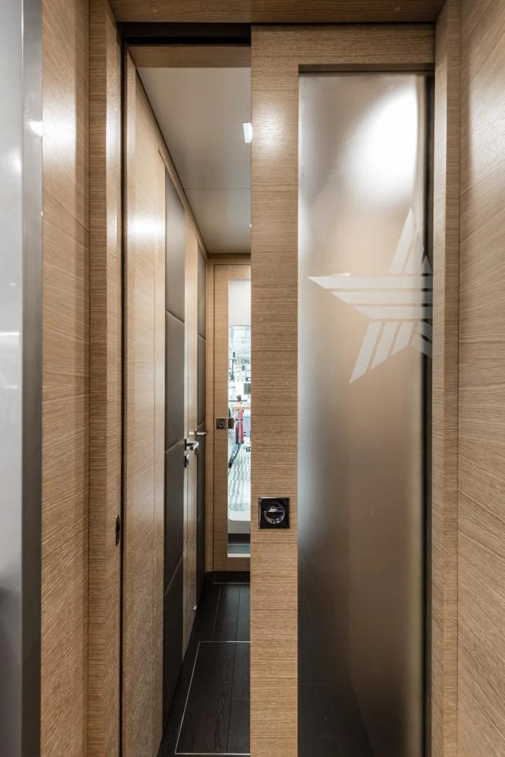 a hallway with a door aboard WINGS SPREAD Yacht for Sale