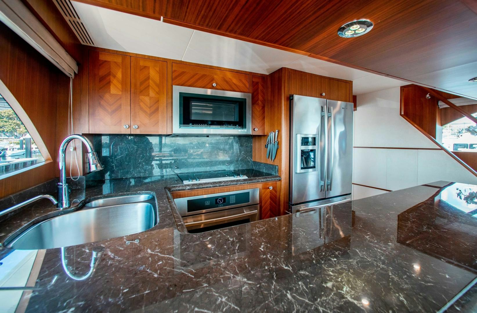 a kitchen with stainless steel appliances aboard TRINITY Yacht for Sale
