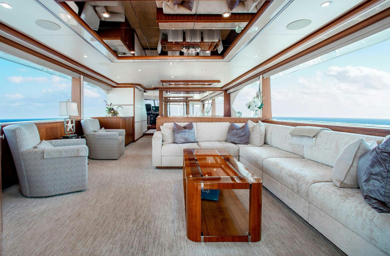a living room with a couch and a table aboard TRINITY Yacht for Sale