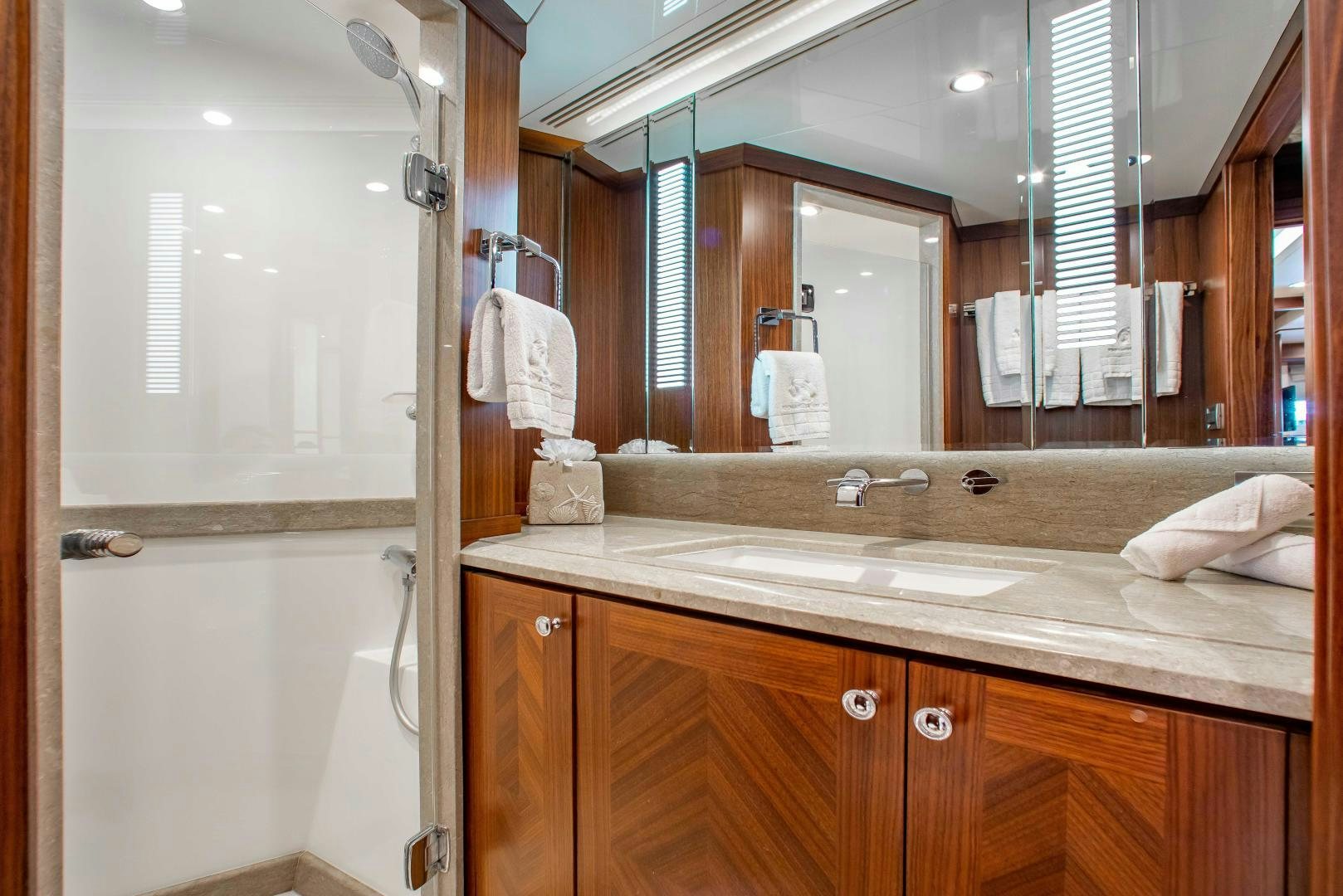 a bathroom with a large mirror aboard TRINITY Yacht for Sale
