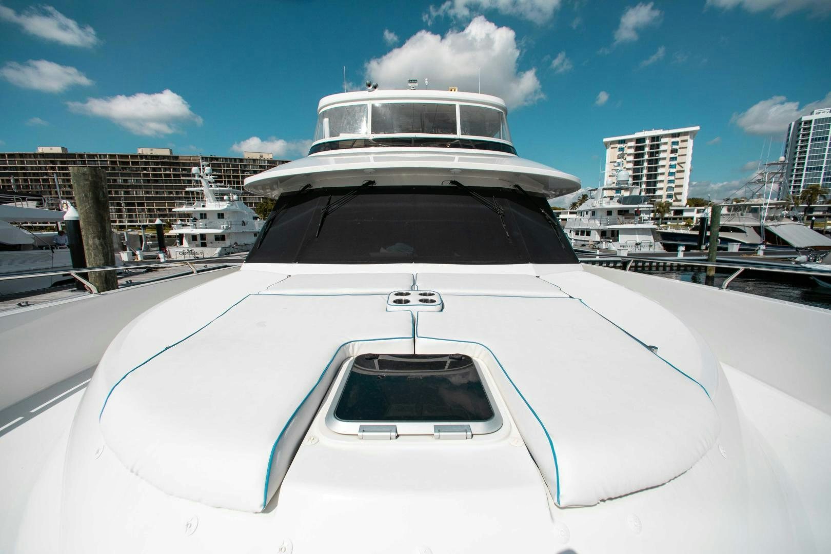 a white yacht in a harbor aboard TRINITY Yacht for Sale