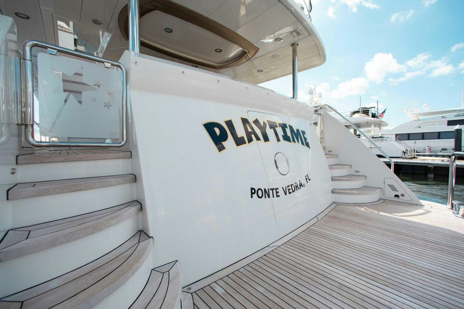 a white boat on a dock aboard TRINITY Yacht for Sale