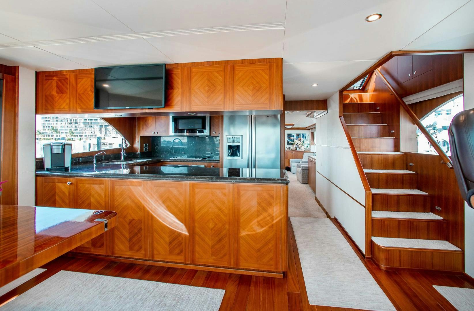 a kitchen with wooden cabinets aboard TRINITY Yacht for Sale
