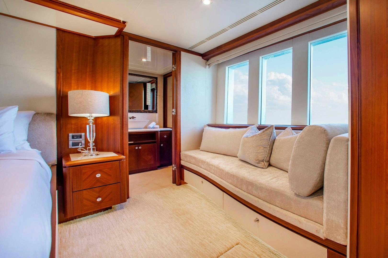 a bedroom with a bed and a couch aboard TRINITY Yacht for Sale