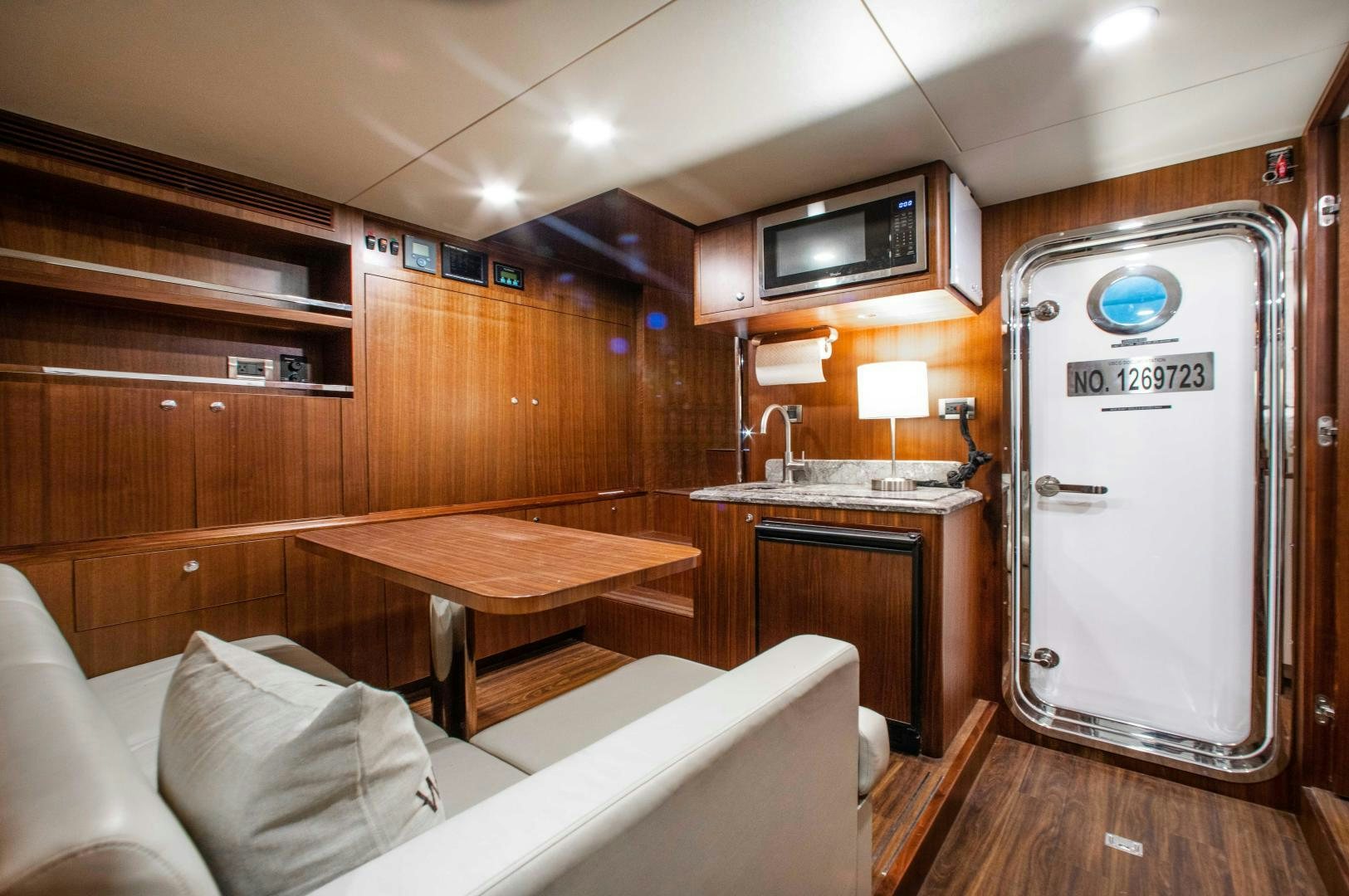 a kitchen with a refrigerator and a sink aboard TRINITY Yacht for Sale