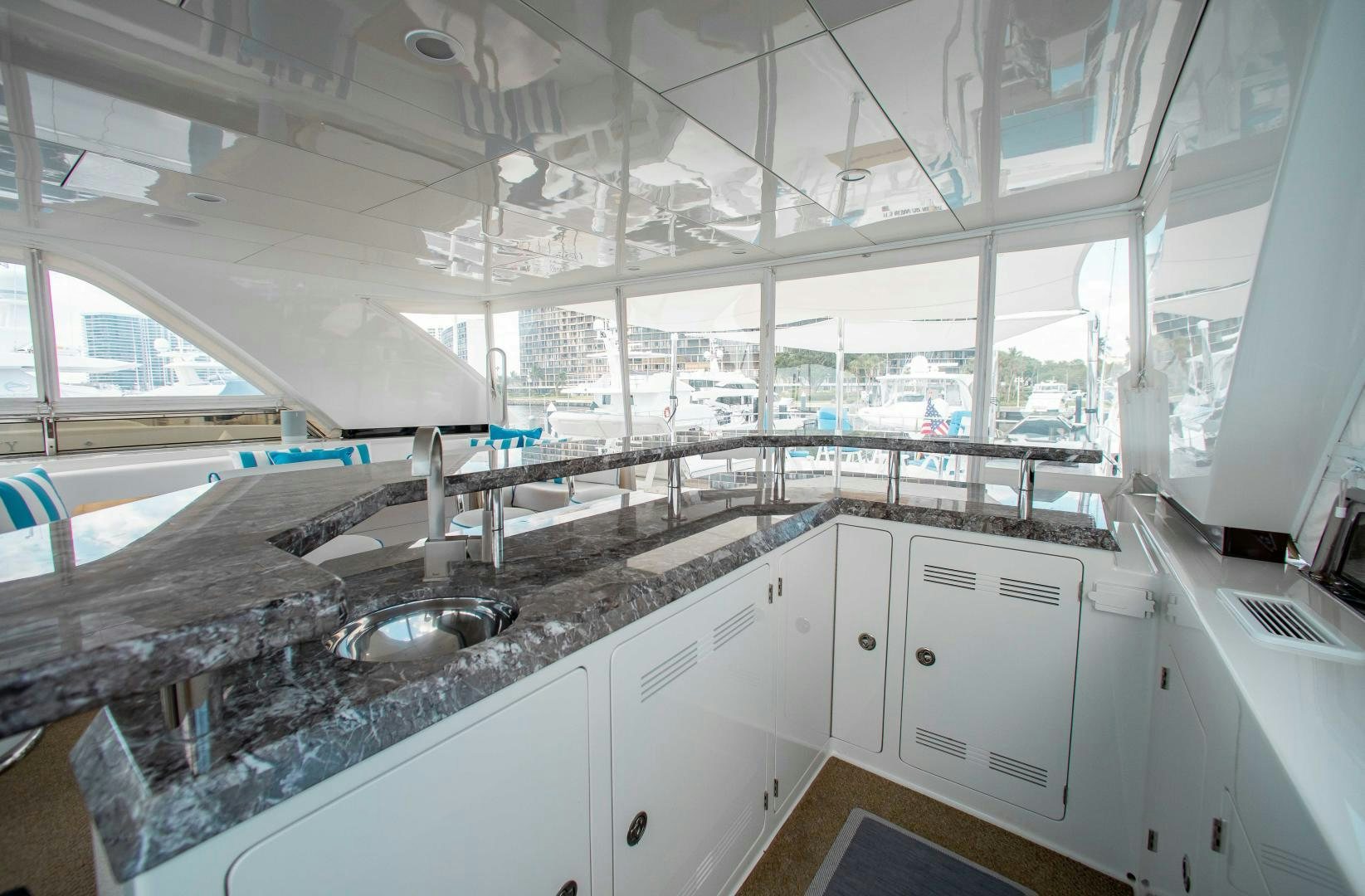 a large kitchen with white cabinets aboard TRINITY Yacht for Sale