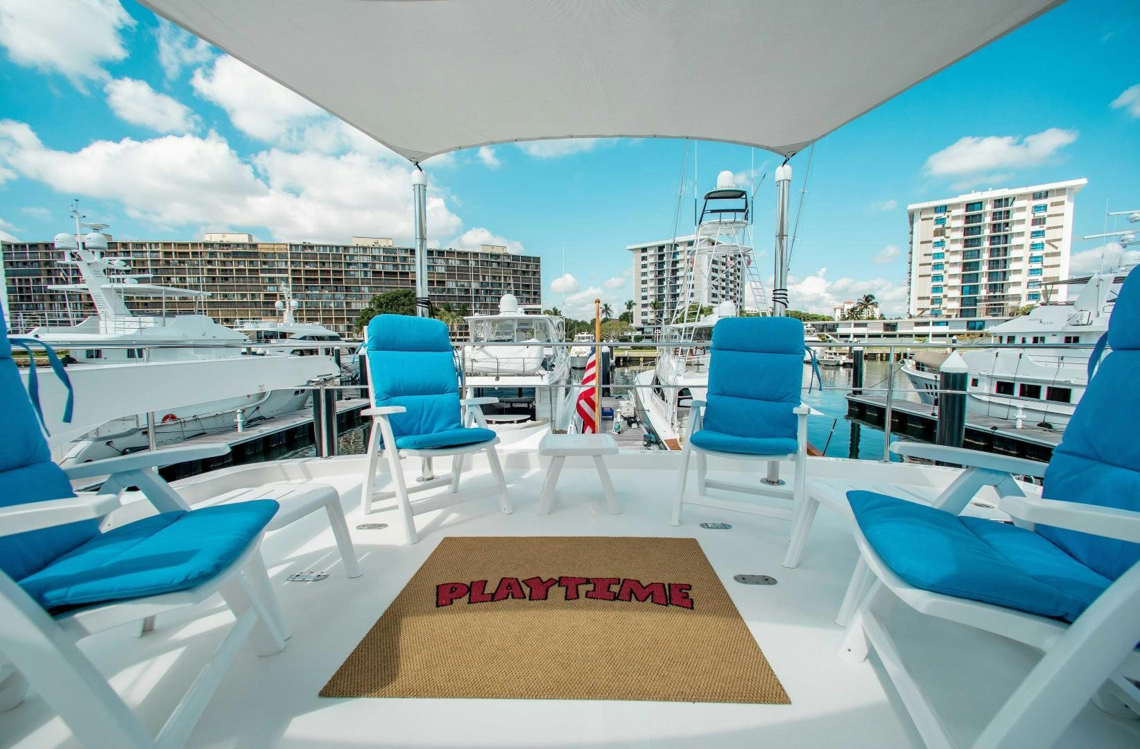 a deck with chairs and a table on it aboard TRINITY Yacht for Sale