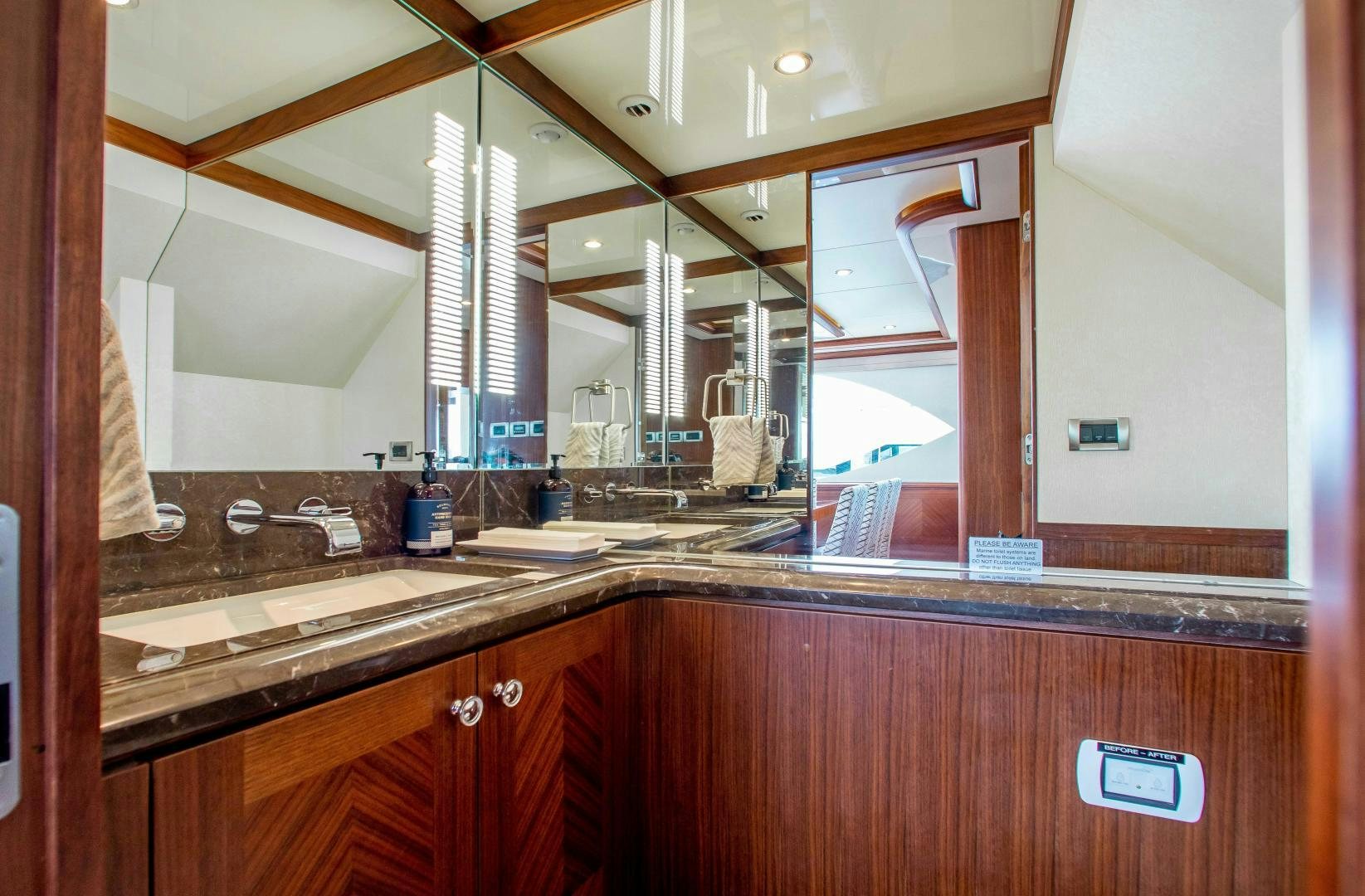 a kitchen with a sink and a mirror aboard TRINITY Yacht for Sale