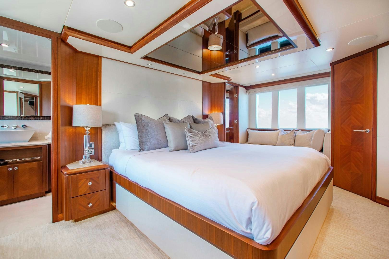 a bedroom with a bed and a desk aboard TRINITY Yacht for Sale