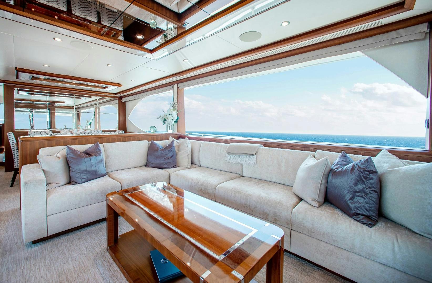 a living room with a couch and a table aboard TRINITY Yacht for Sale