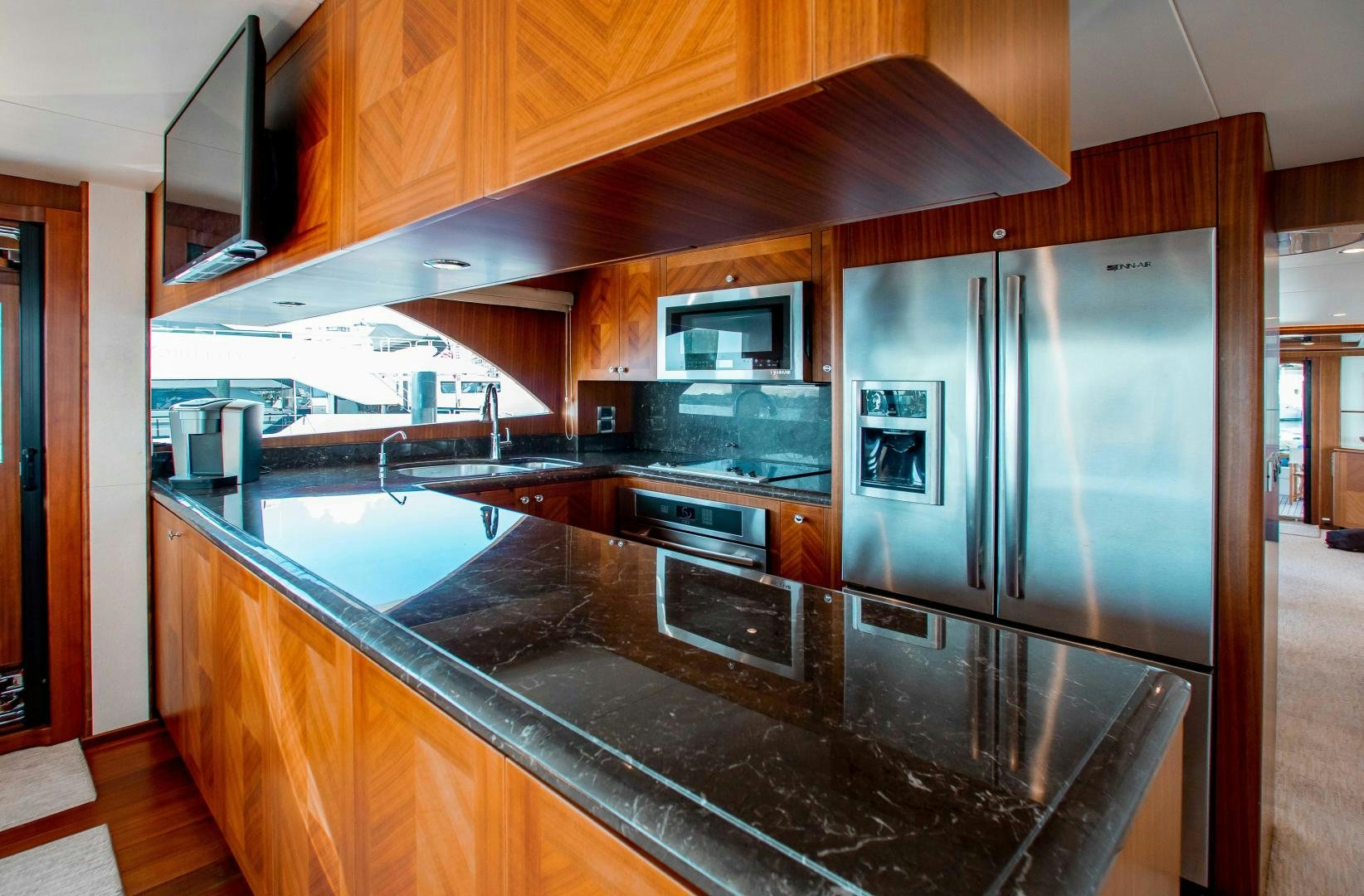 a kitchen with stainless steel appliances aboard TRINITY Yacht for Sale