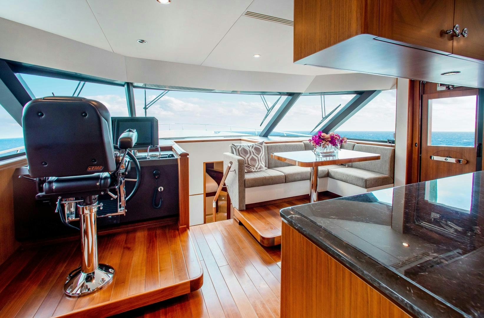 a room with a table and a couch aboard TRINITY Yacht for Sale