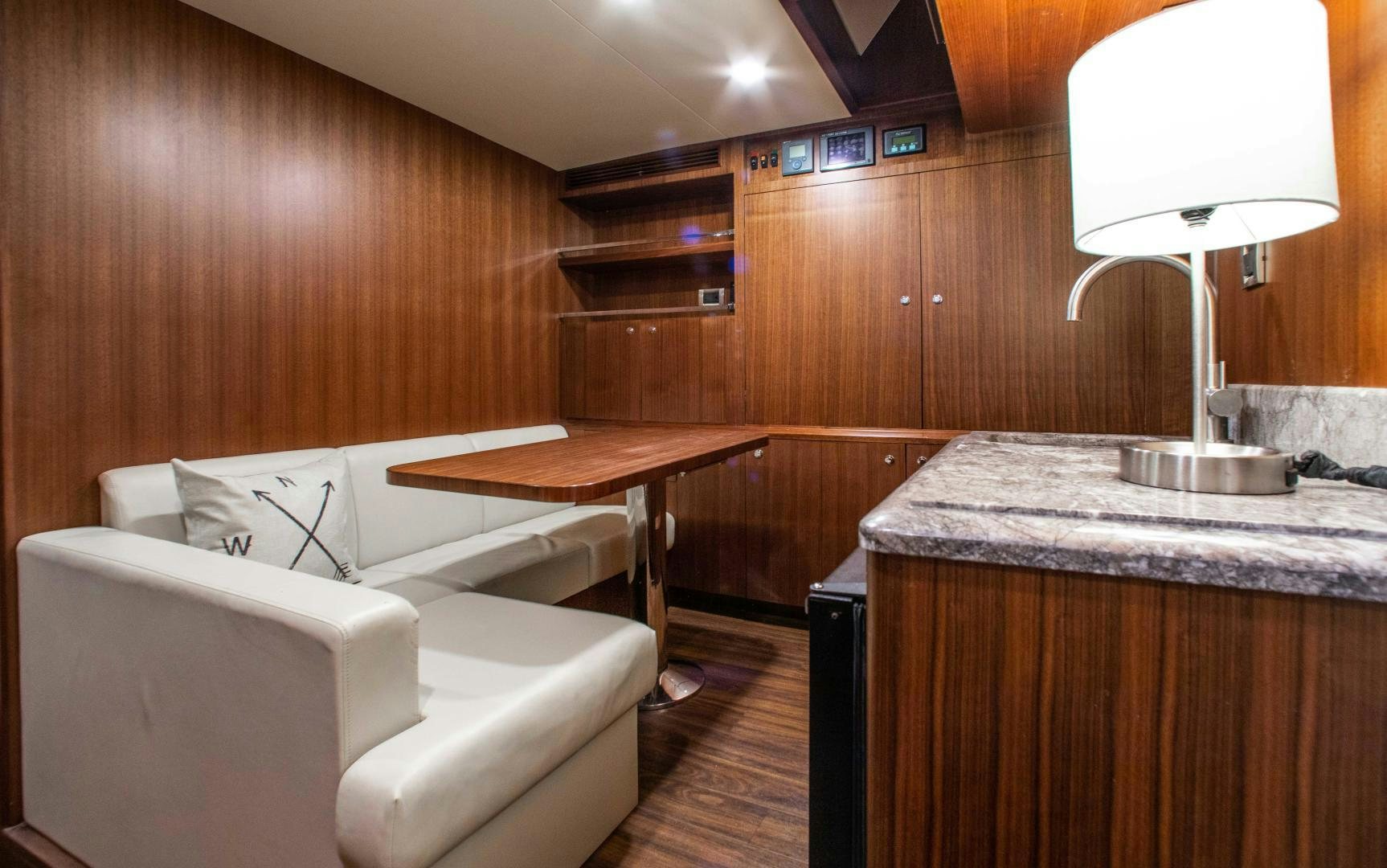 a living room with a couch and a table aboard TRINITY Yacht for Sale