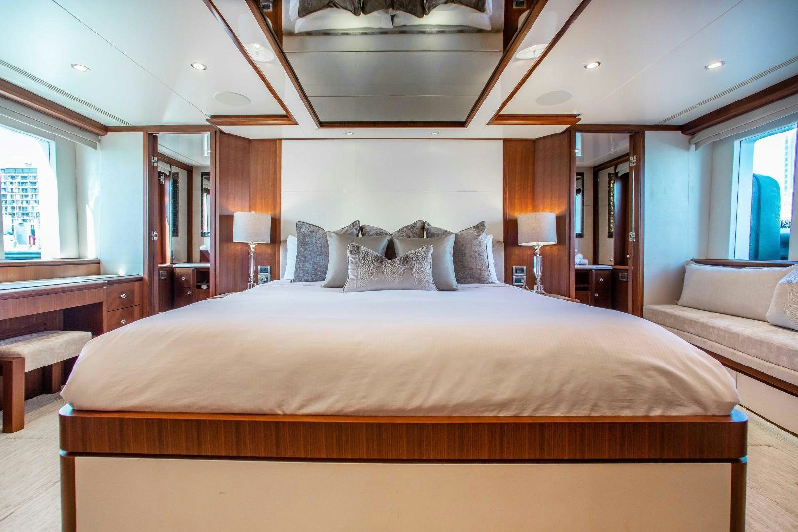 a bed with a white bed spread aboard TRINITY Yacht for Sale