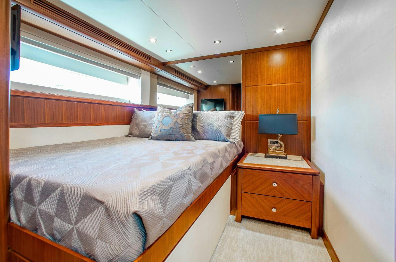 a bedroom with a bed and a television aboard TRINITY Yacht for Sale