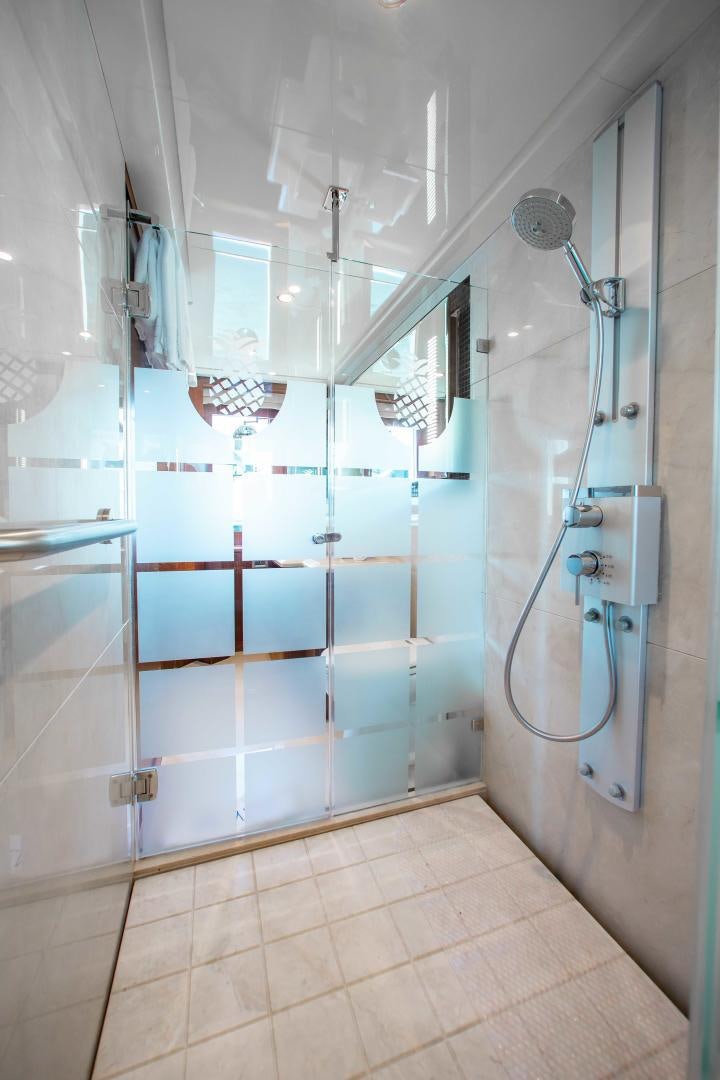 a shower with a glass door aboard TRINITY Yacht for Sale