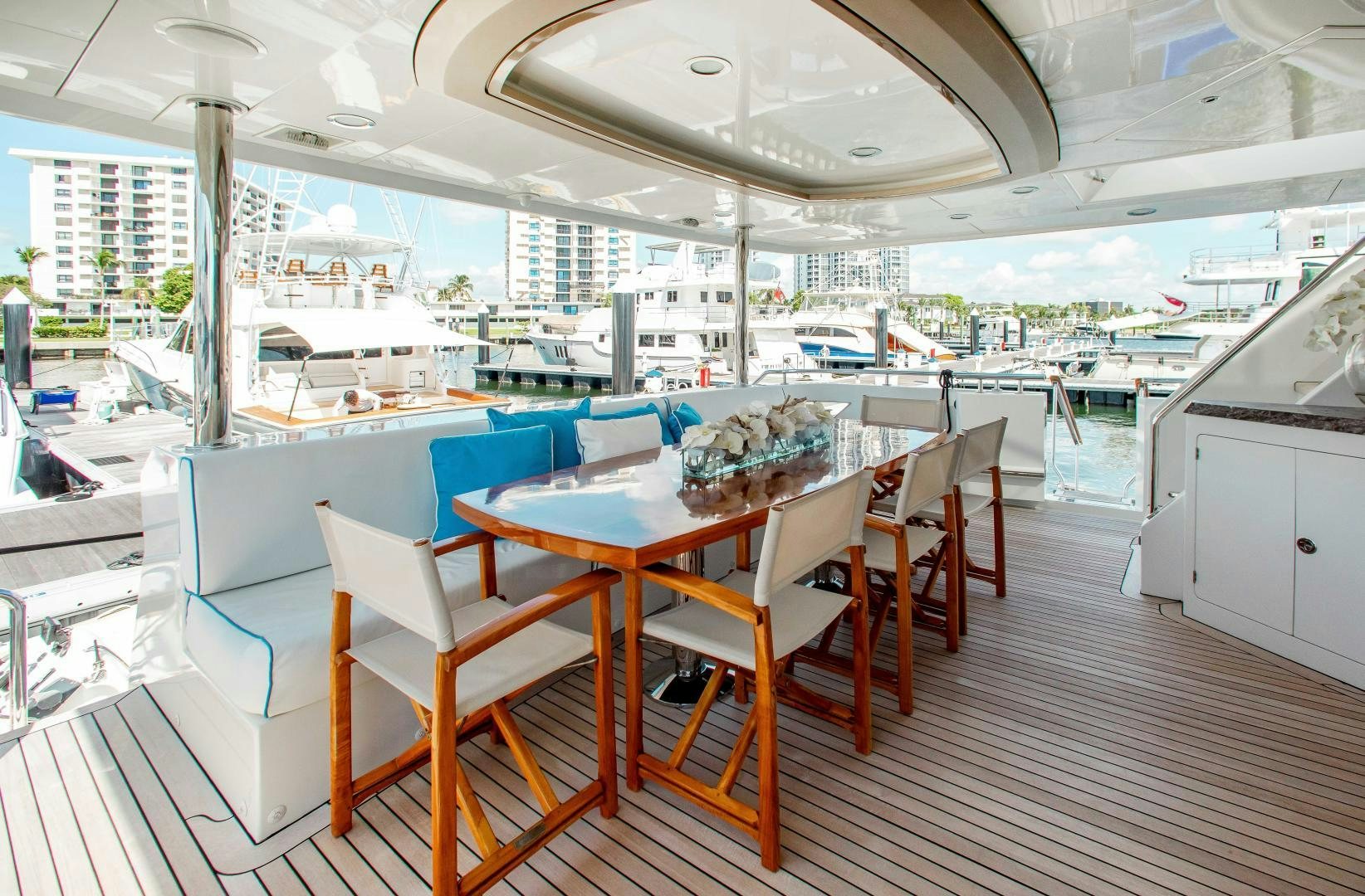 a room with tables and chairs aboard TRINITY Yacht for Sale