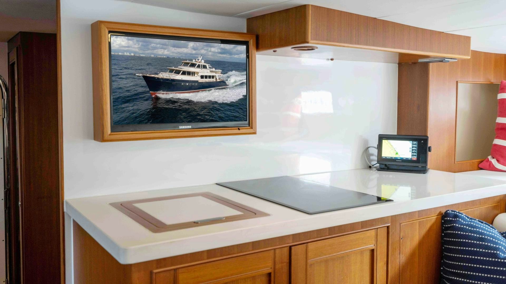 a desk with a computer and a television on it aboard NEVER MY LOVE Yacht for Sale