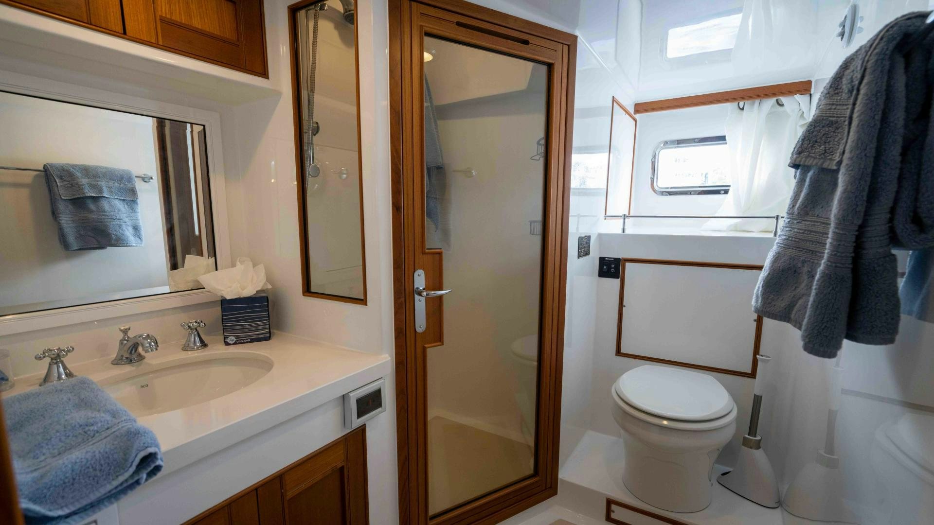 a bathroom with a toilet and sink aboard NEVER MY LOVE Yacht for Sale