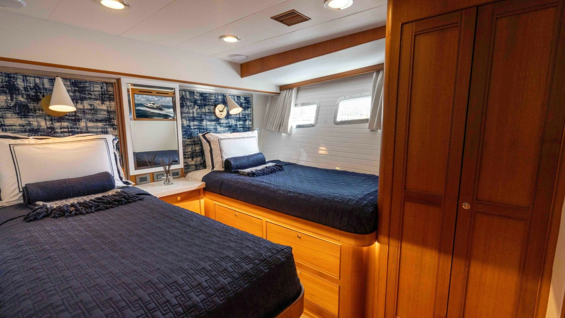 a bedroom with a bed and a desk aboard NEVER MY LOVE Yacht for Sale